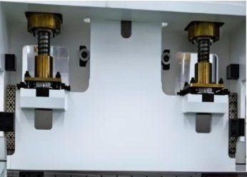 Close view of the press brake screw drives and guidance arrangement